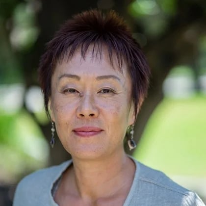 a woman with short hair wearing earrings