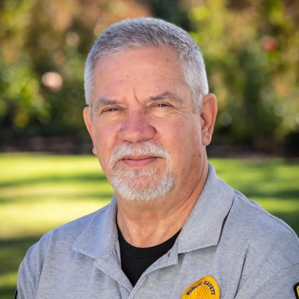 a man with a white beard and a gray shirt