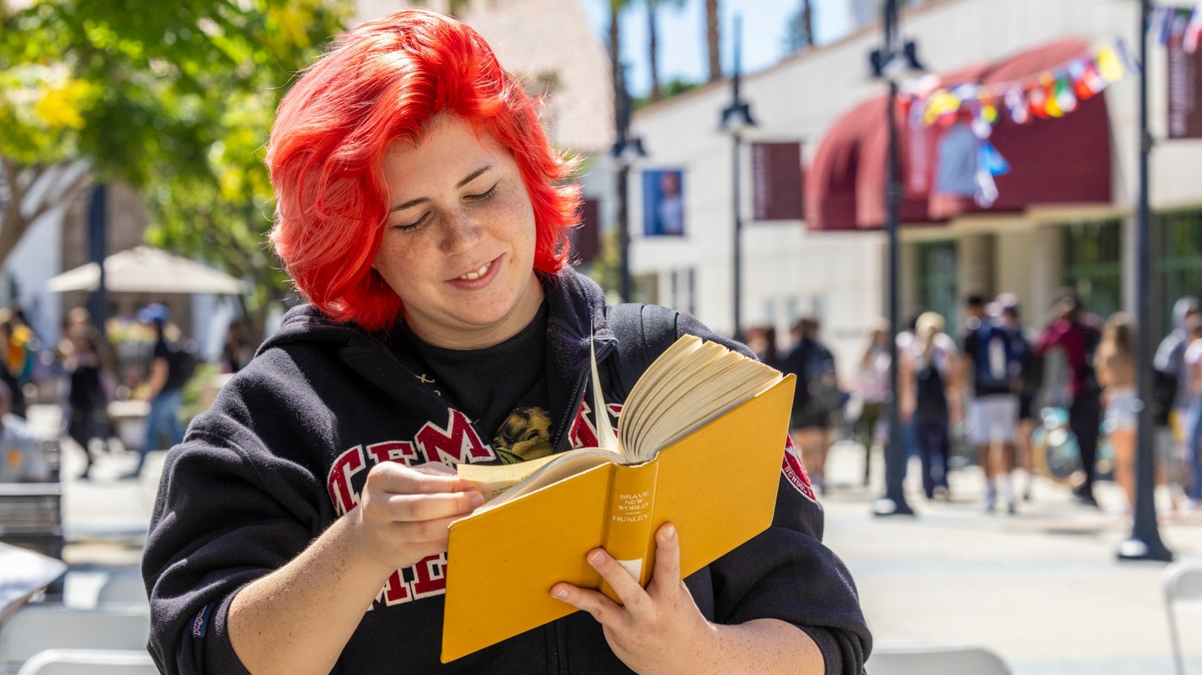 a woman with red hair reading a book