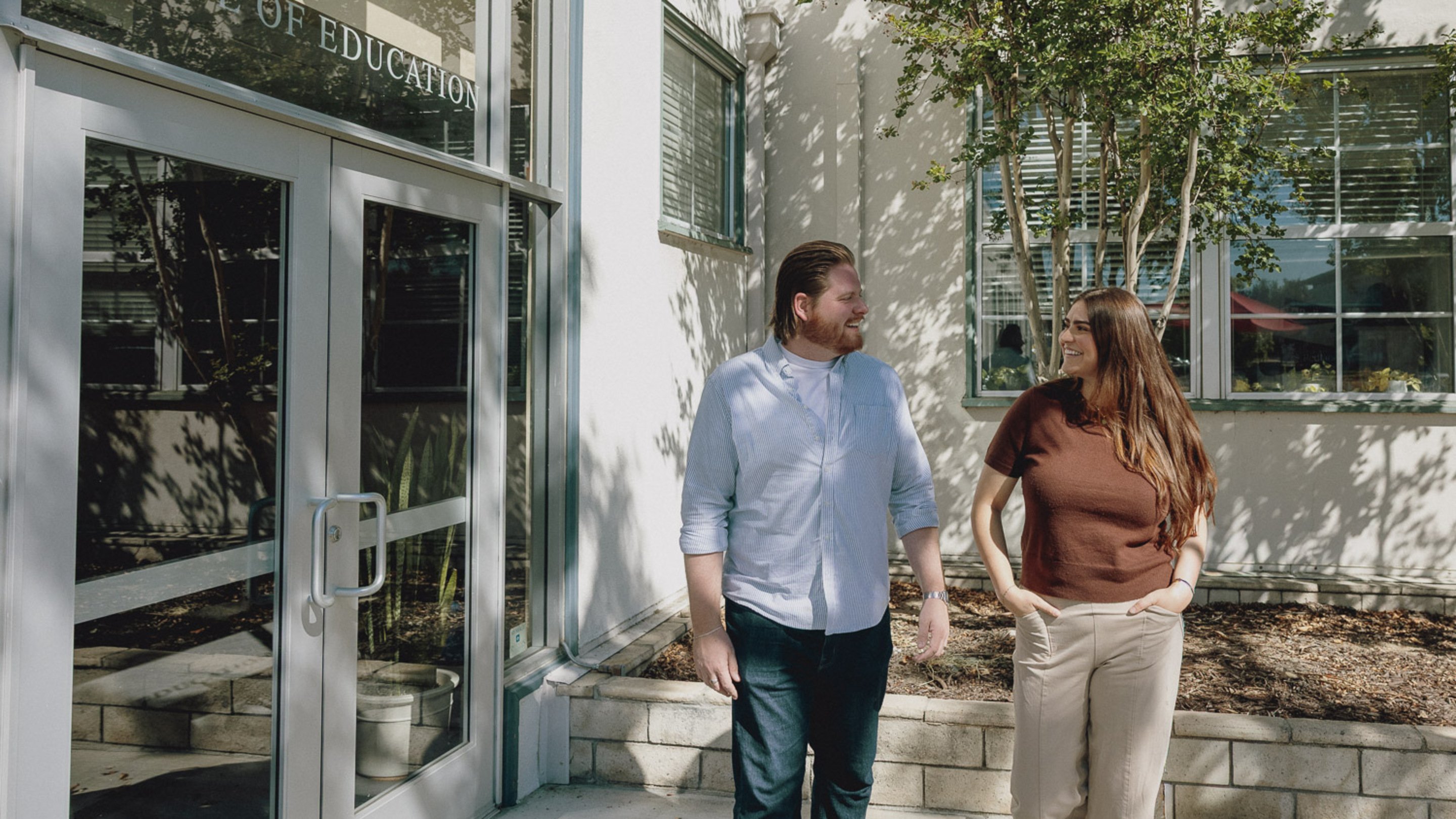 a person and person standing outside of a building