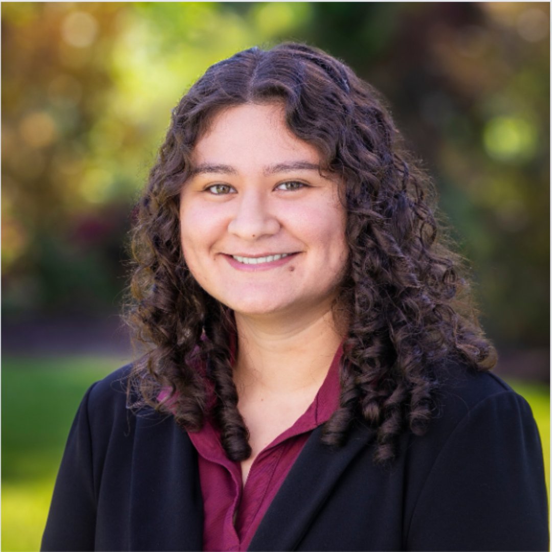 a woman with curly hair smiling