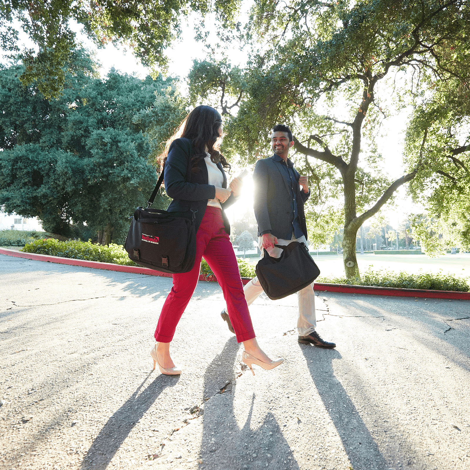 a man and woman walking on a road