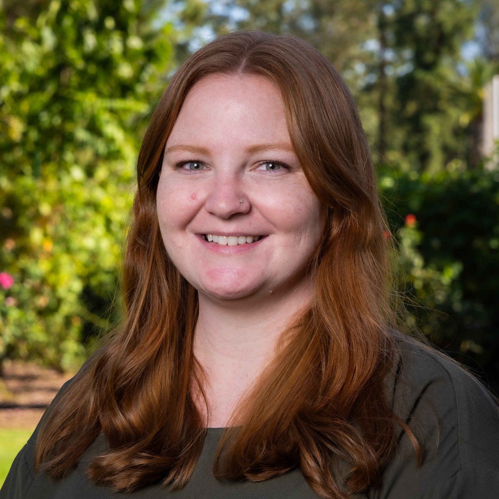 a woman with long hair smiling