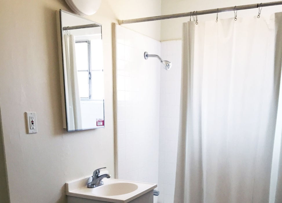 a bathroom with a shower and sink