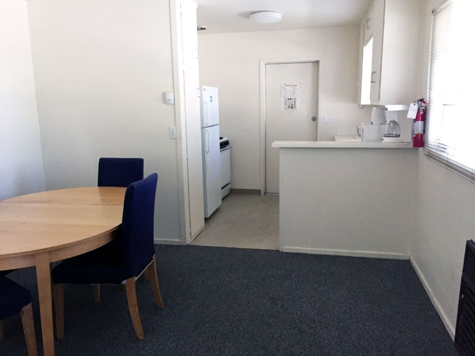 a kitchen with a table and a refrigerator