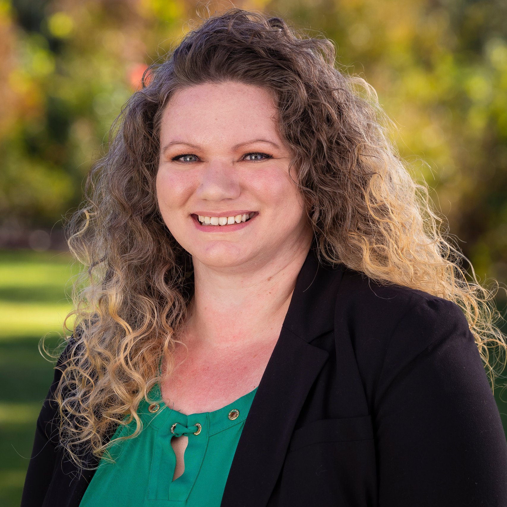 a woman with curly hair smiling