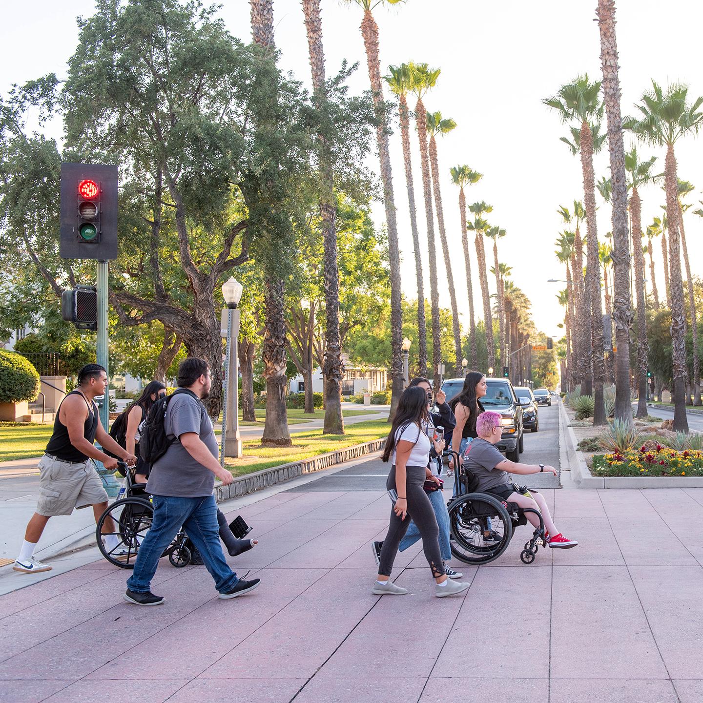 a group of people crossing a sidewalk