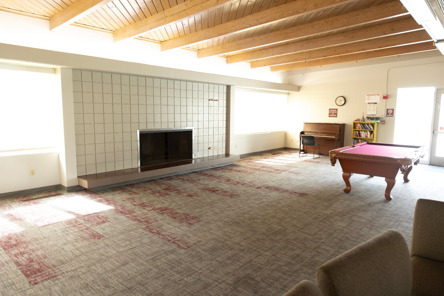 a room with a pool table and a fireplace