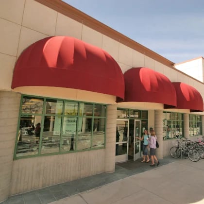 a group of people walking in front of a store