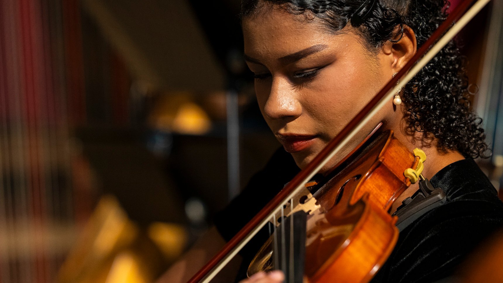 a woman playing a violin