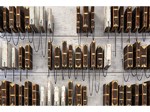 a wall with wooden boxes and chains