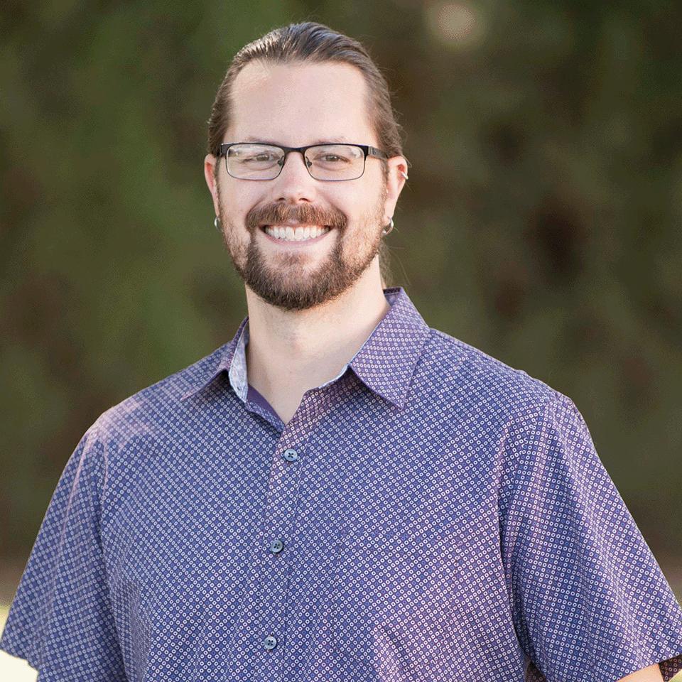 a man wearing glasses and a blue shirt