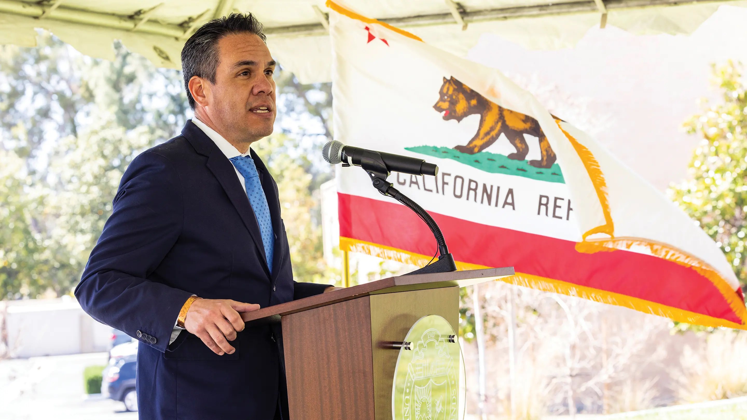 a person standing at a podium with a microphone