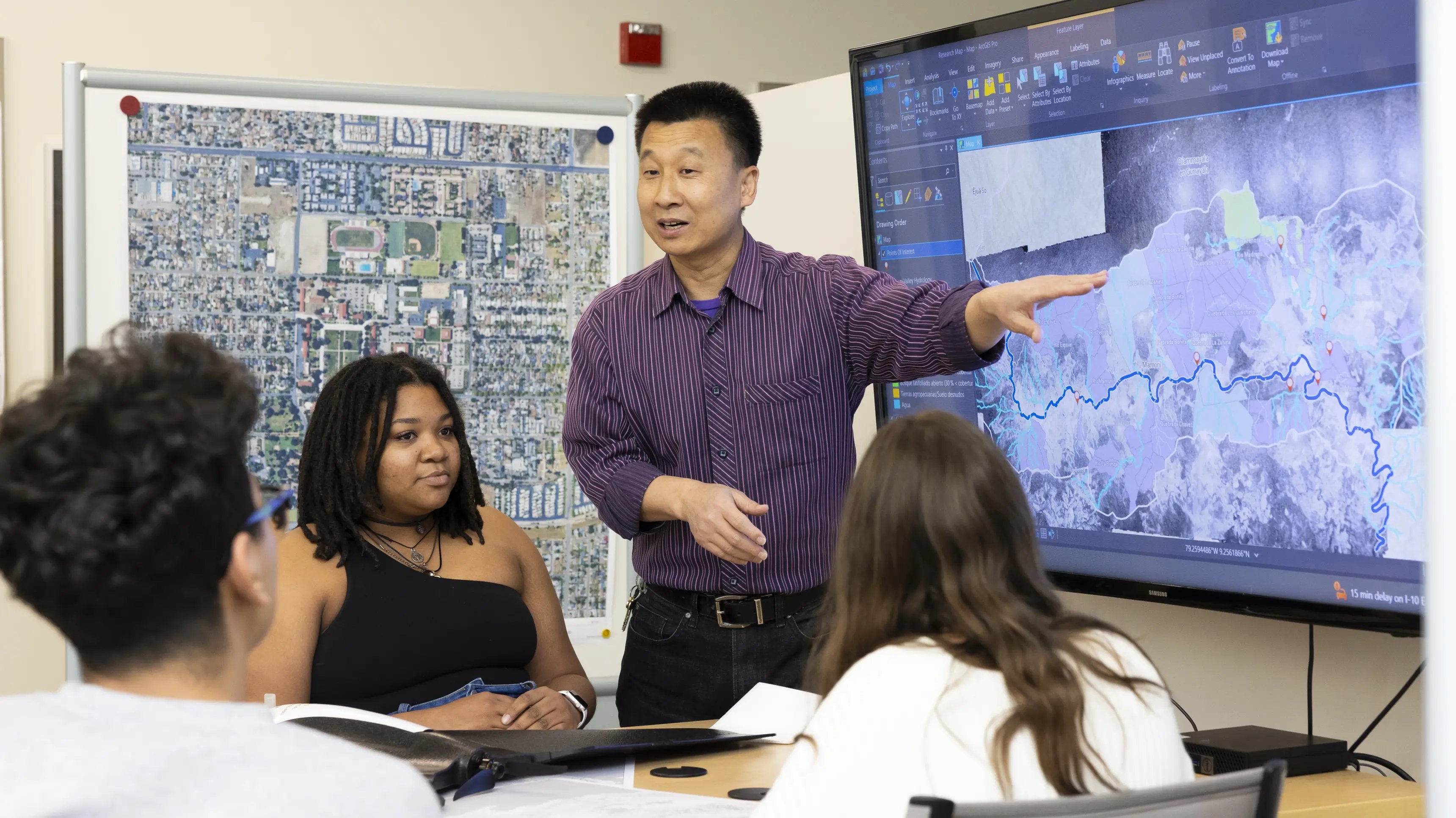 a man pointing at a screen