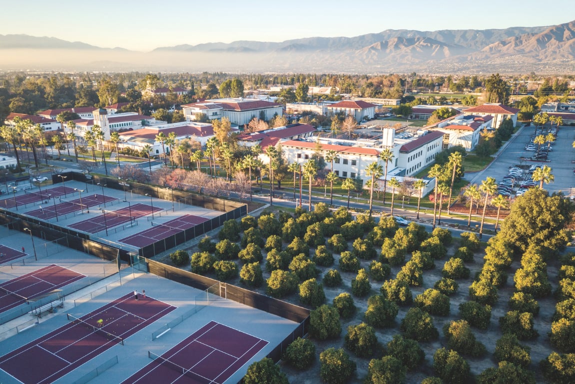 a tennis court and trees in a city