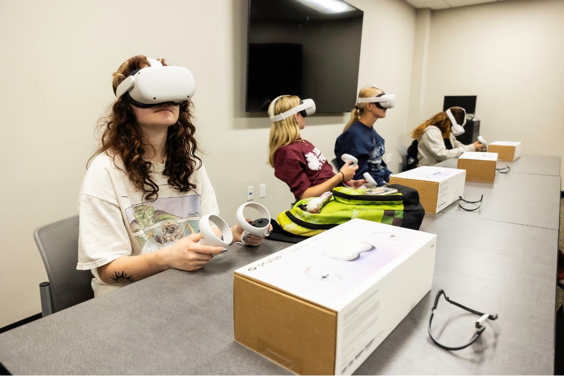 a group of people wearing virtual reality goggles