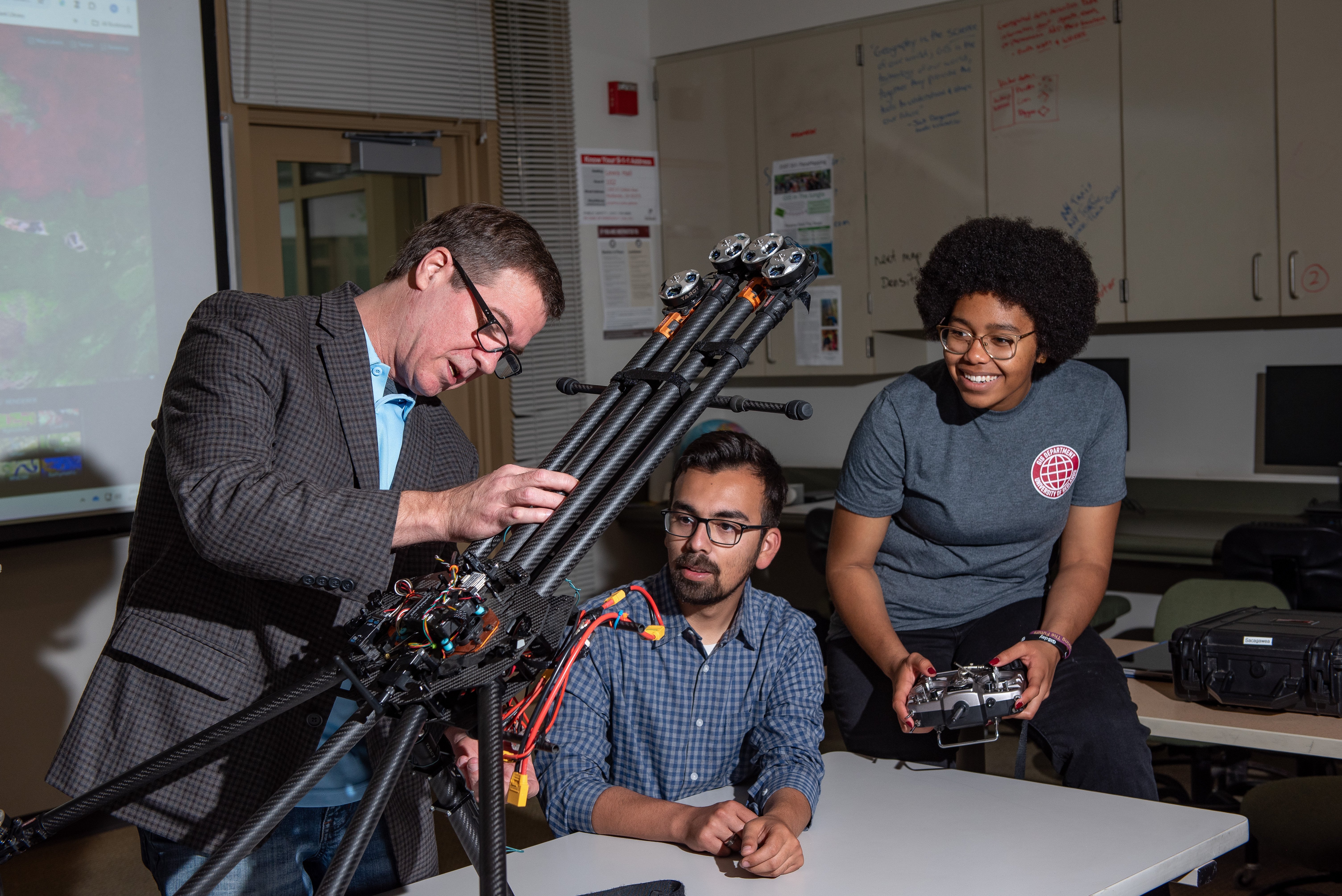 a person standing next to a person holding a machine