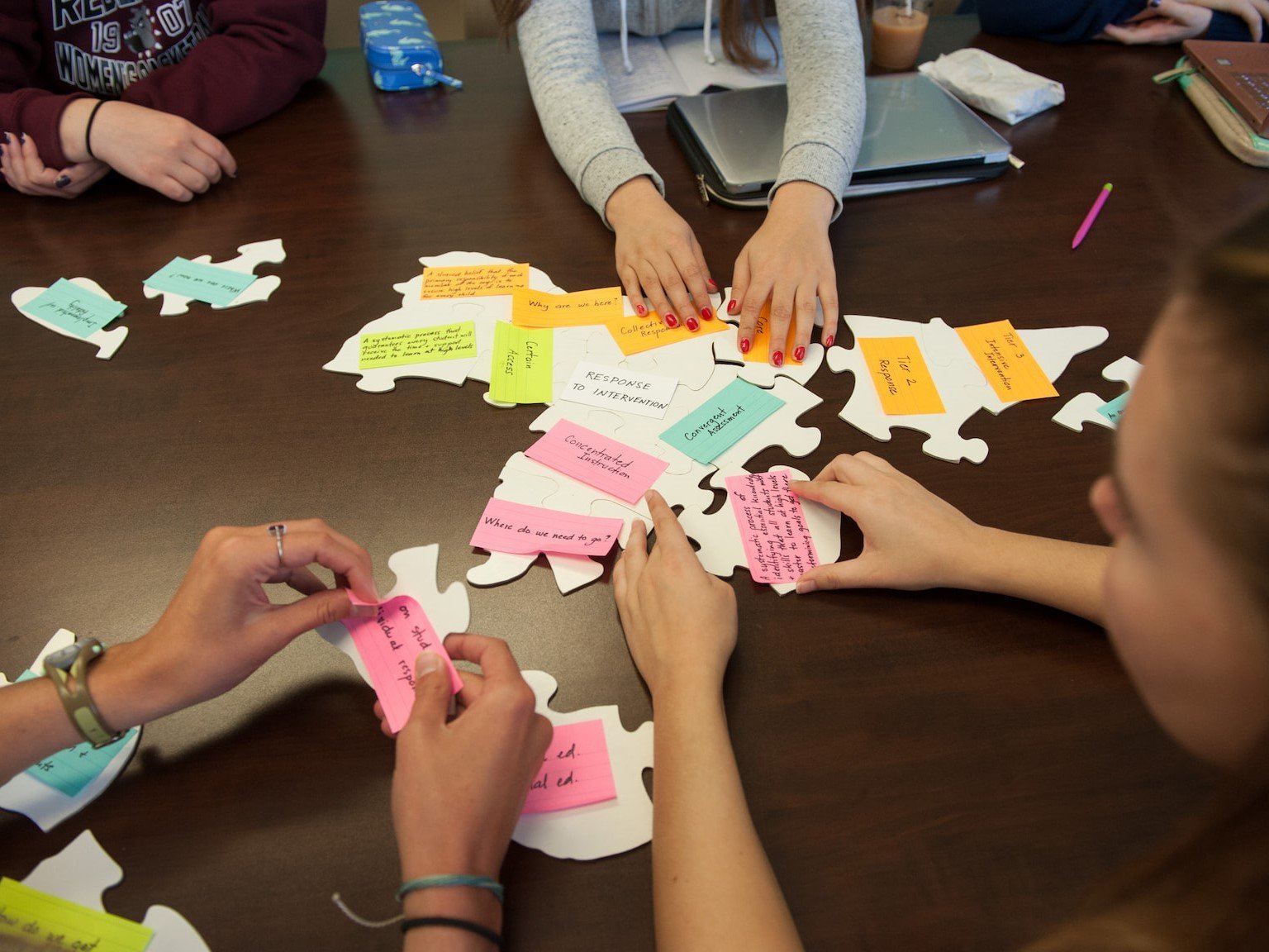 a group of people embling puzzle pieces