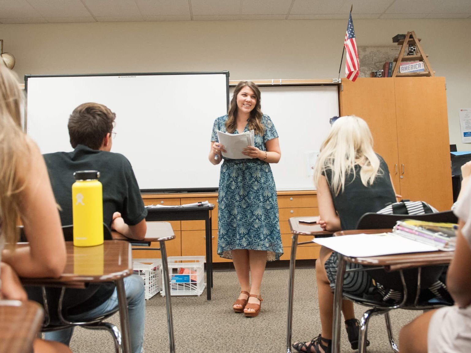 a woman standing in front of a whiteboard