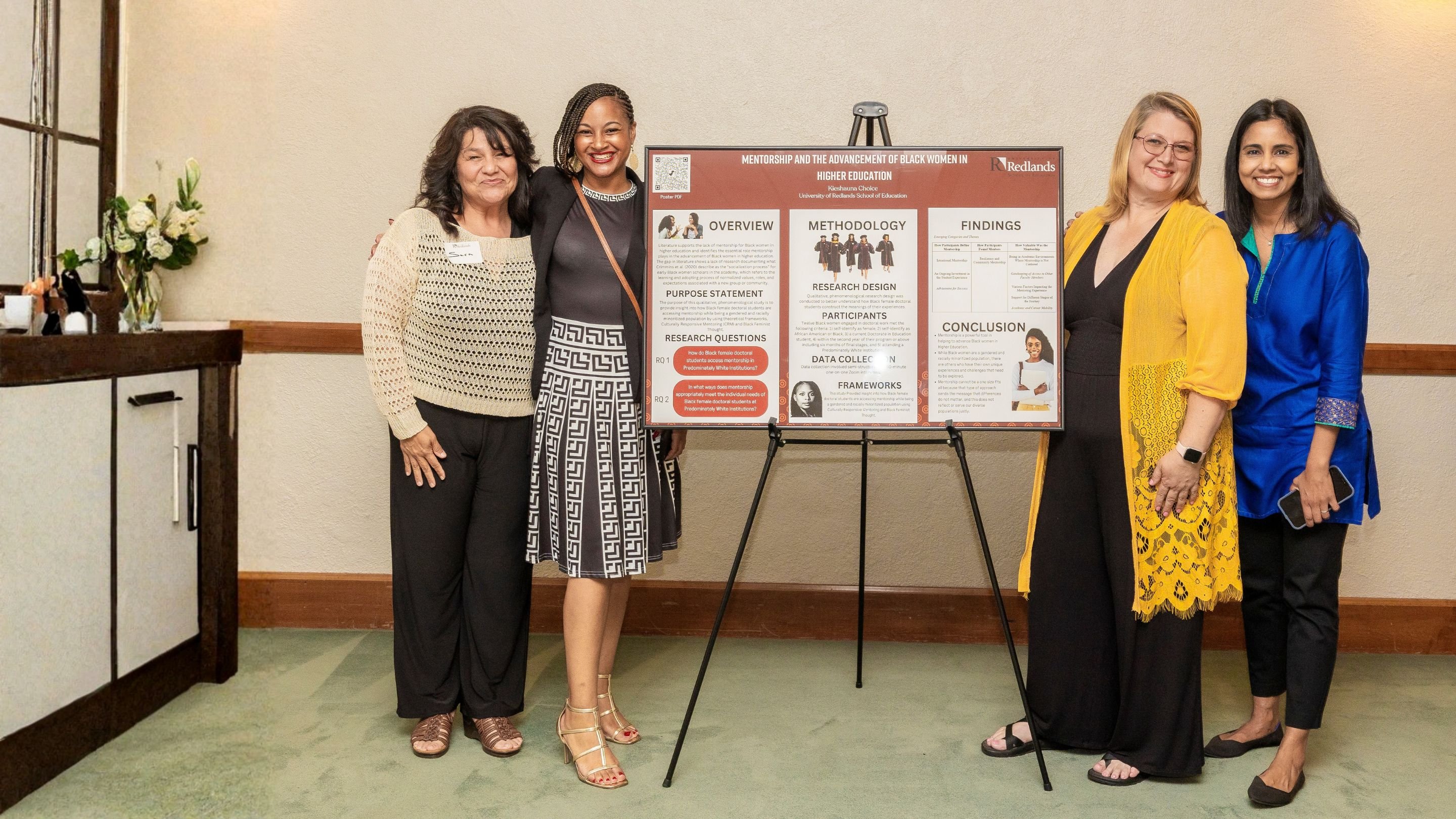 a group of women standing next to a sign