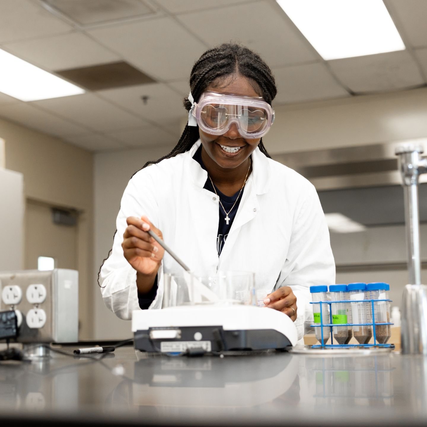 a person wearing goggles and white coat