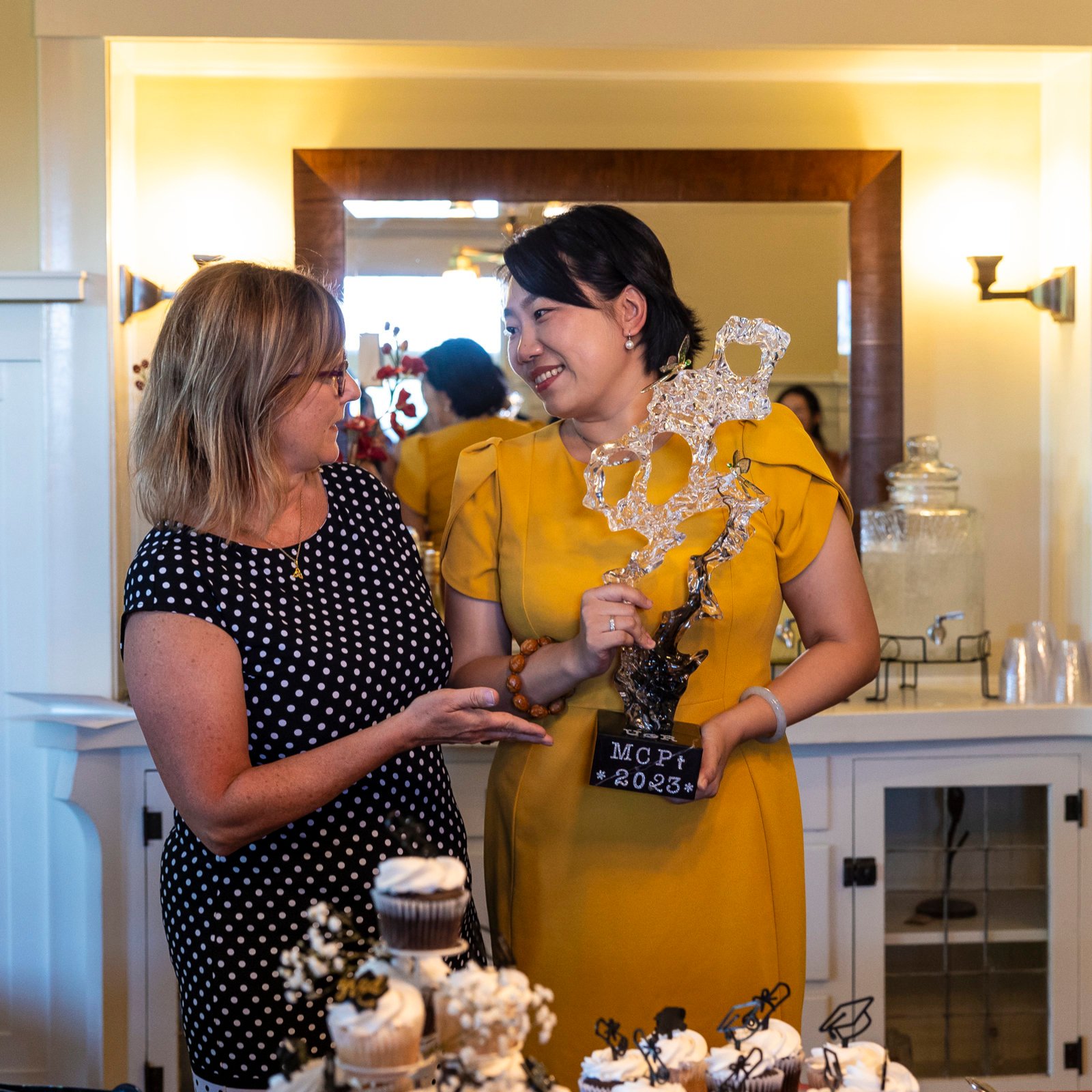 a woman holding a trophy
