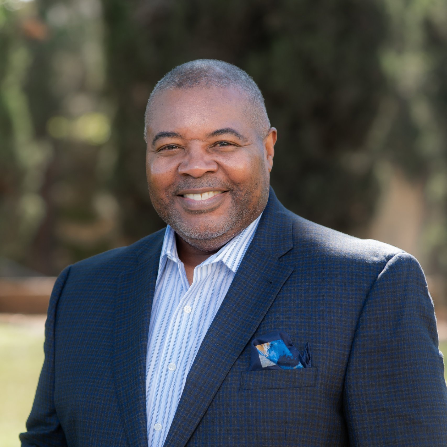 a person in a suit smiling