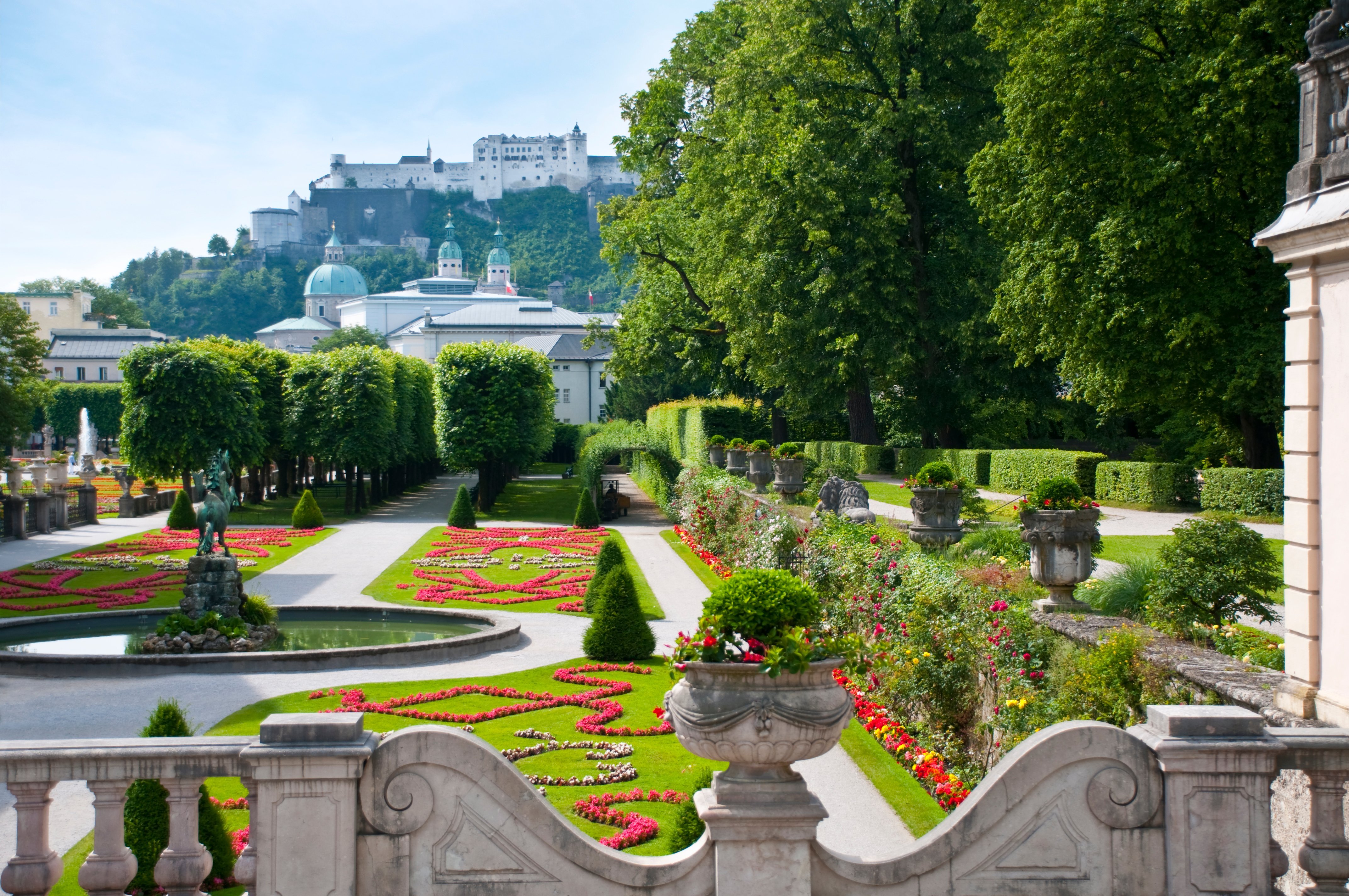 a garden with a castle in the background