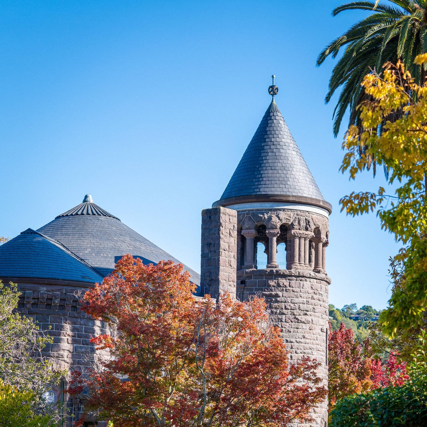 a building with a pointed roof and trees