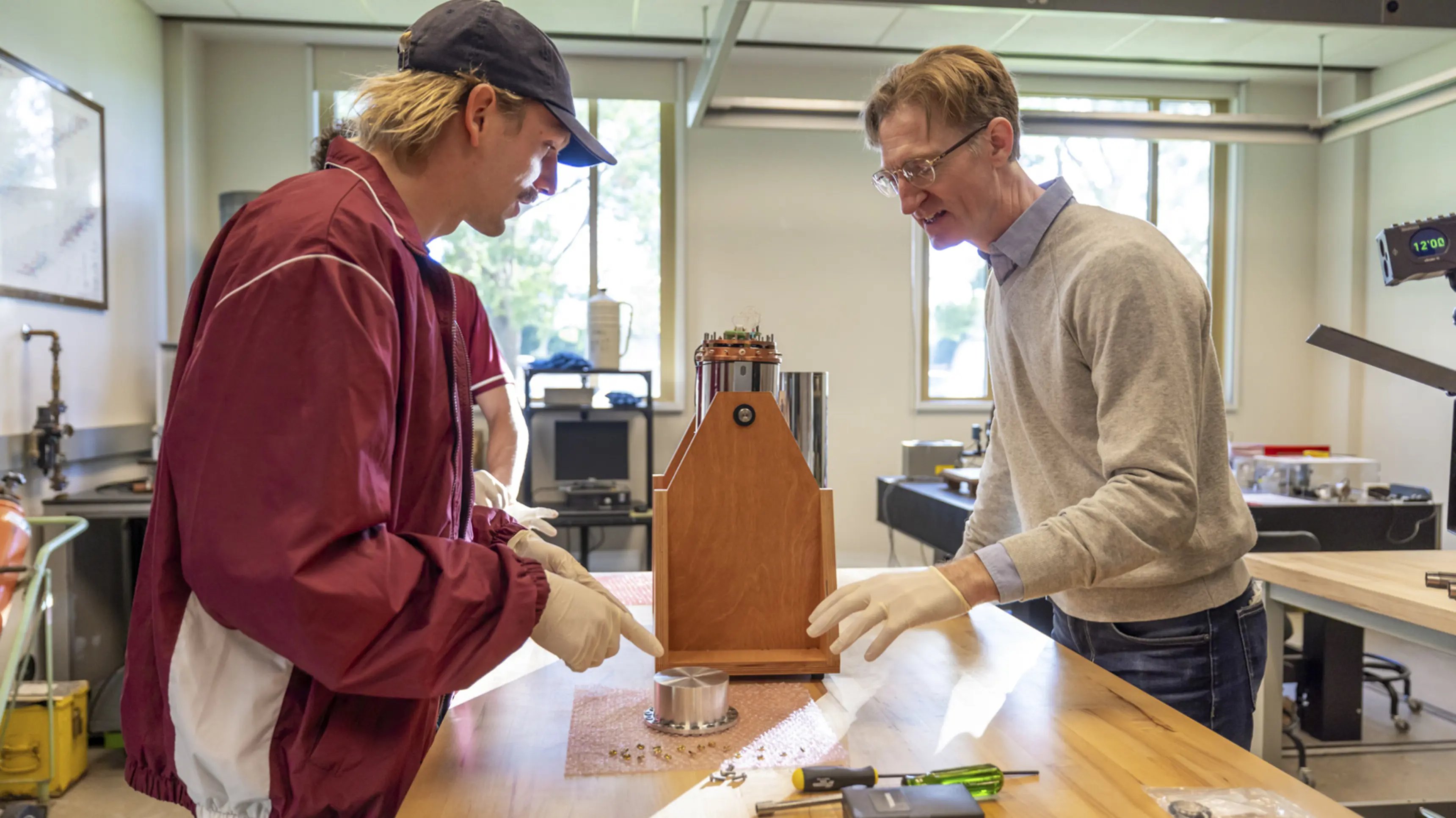 a man pointing at a piece of wood
