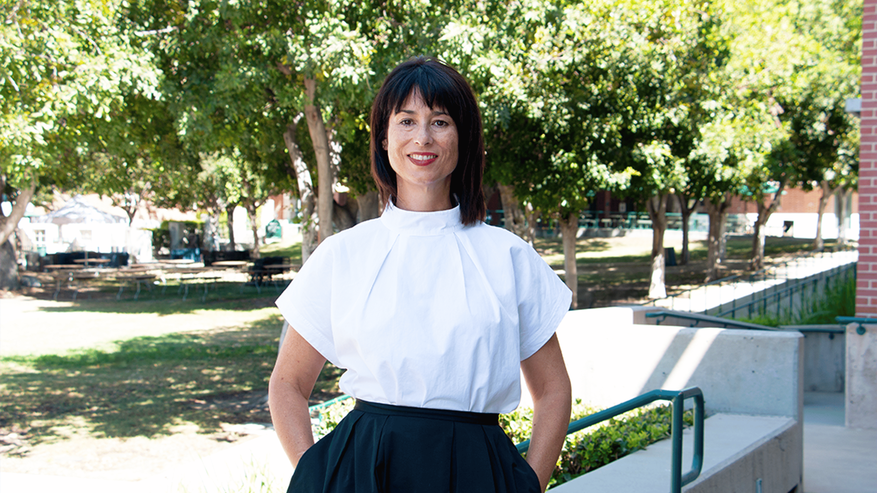a person in a white shirt and black skirt