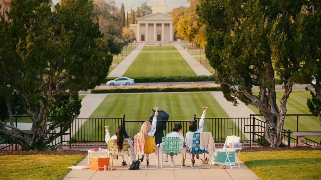 a group of people sitting on chairs in front of a building