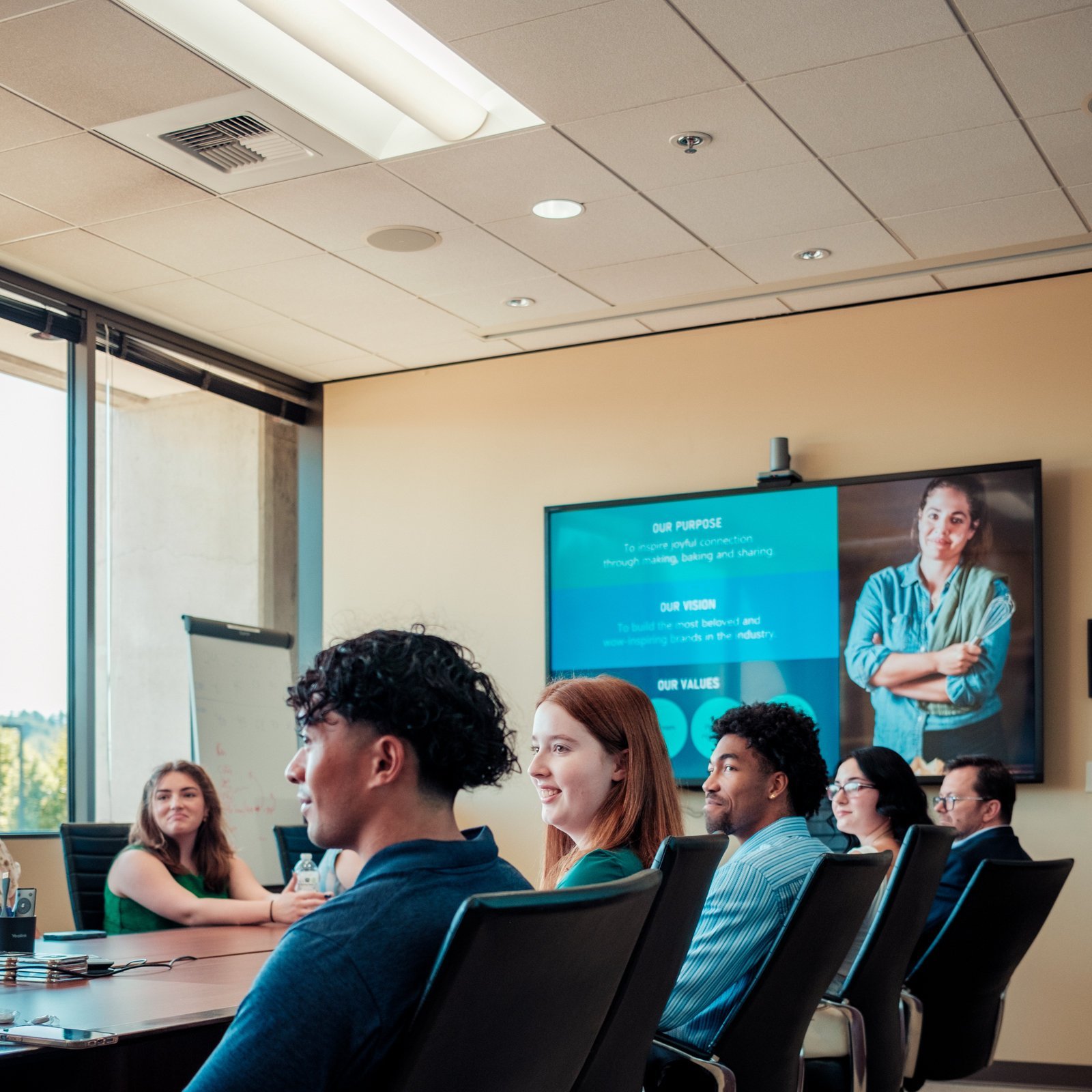 a group of people sitting in a meeting