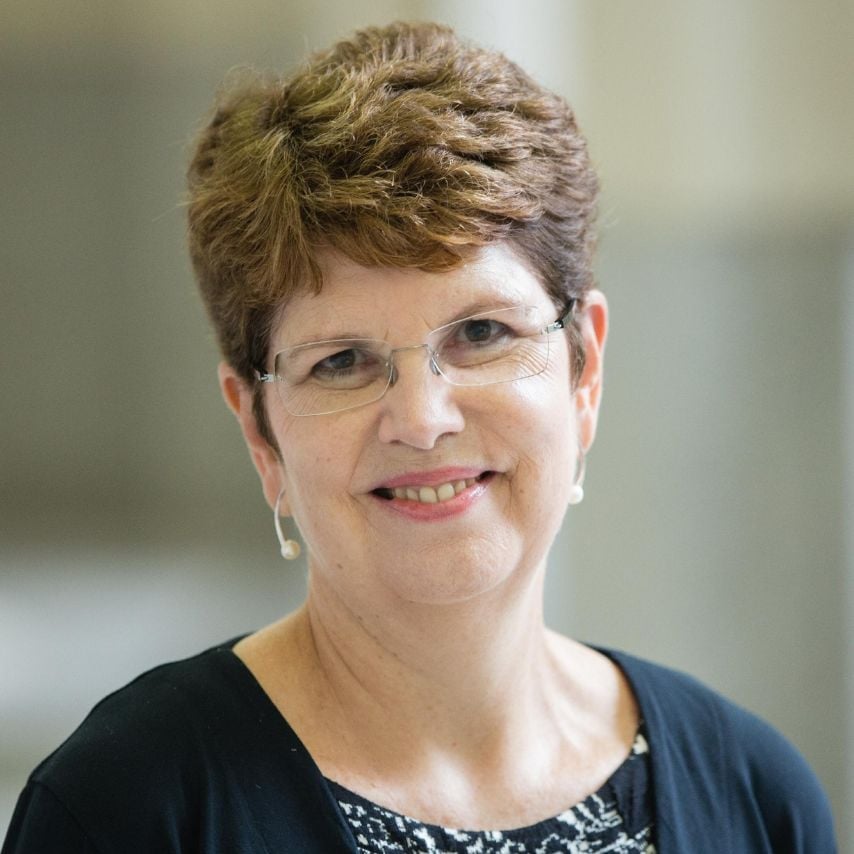 a woman with short hair wearing glasses