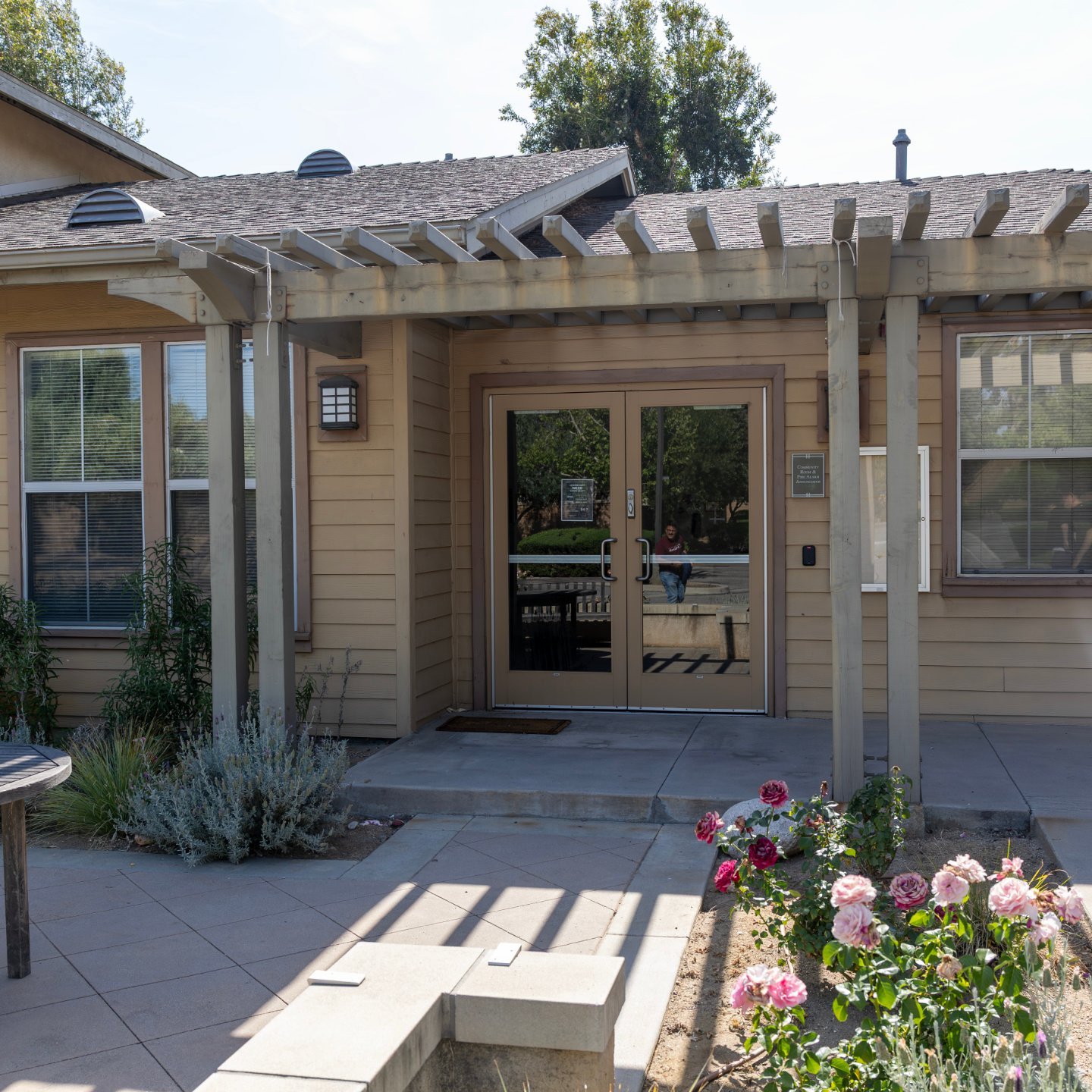 a house with a pergola and flowers