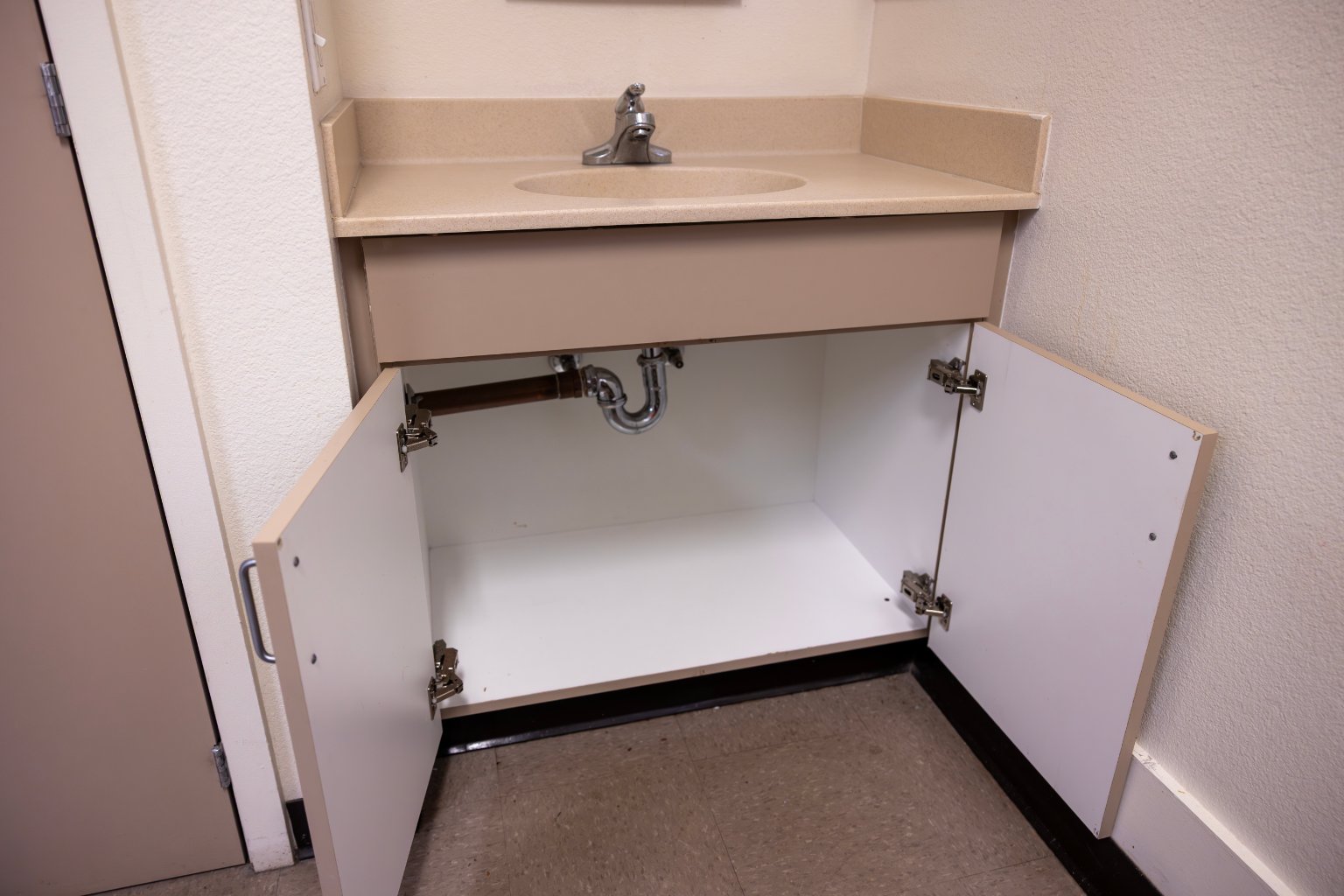 a sink under a cabinet