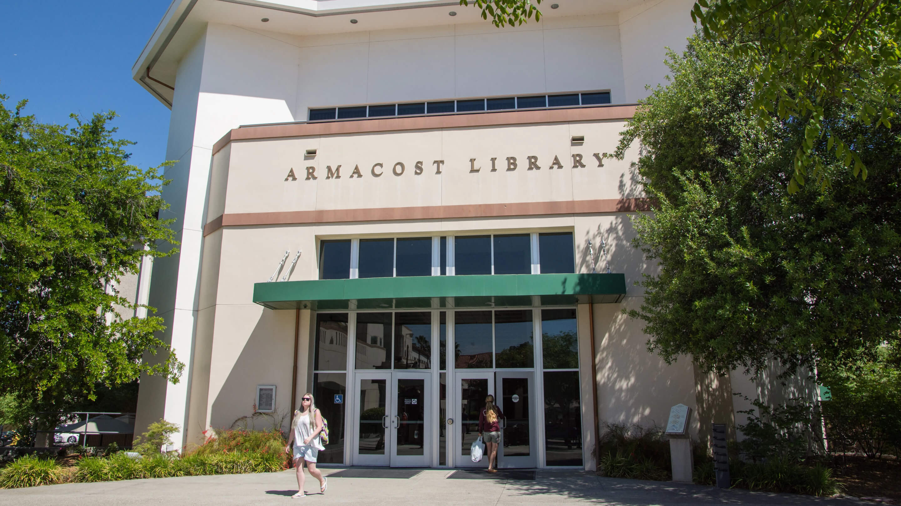 a group of people walking in front of a library