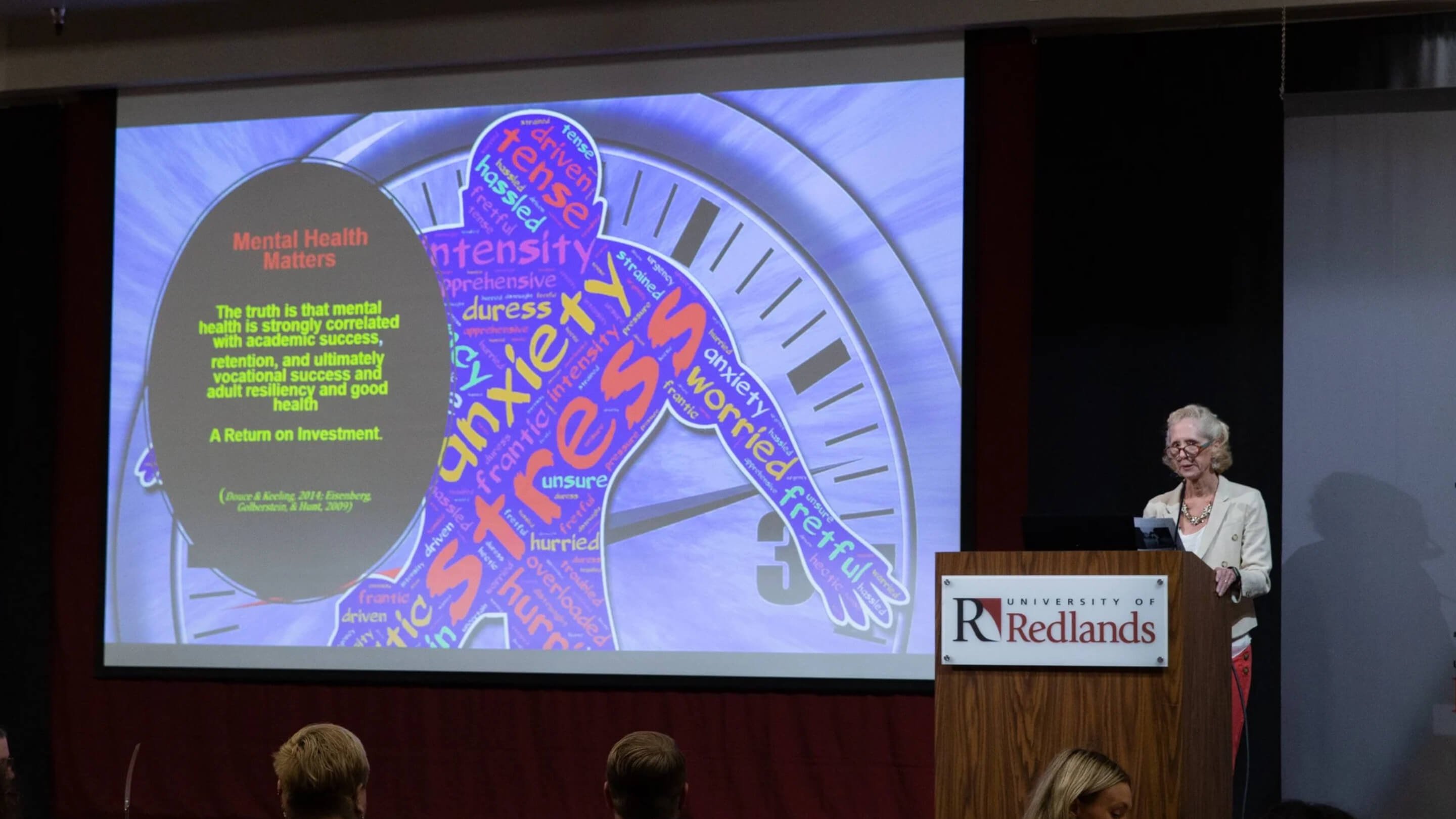 a group of people in front of a podium