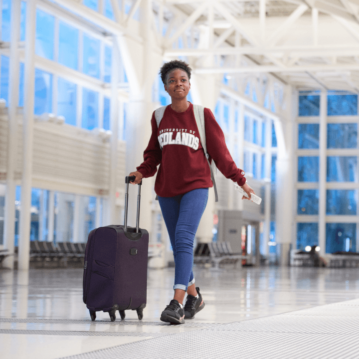 a woman walking with a suitcase
