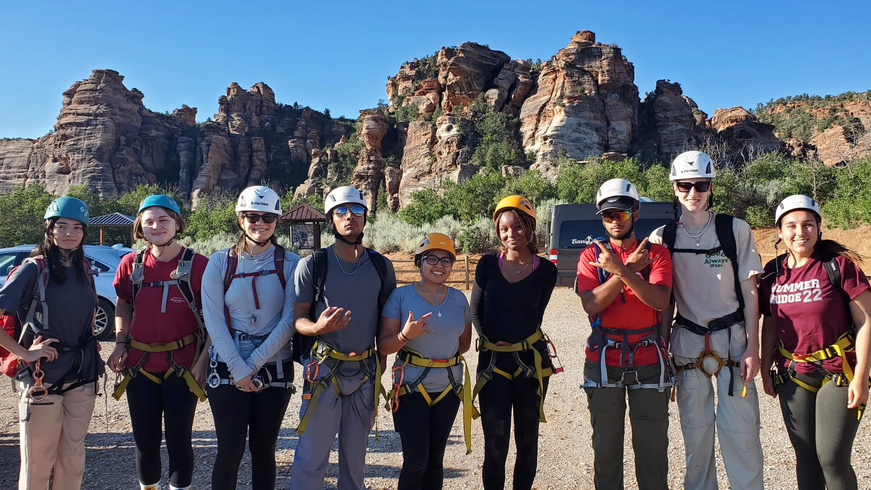a group of people wearing helmets and climbing gear
