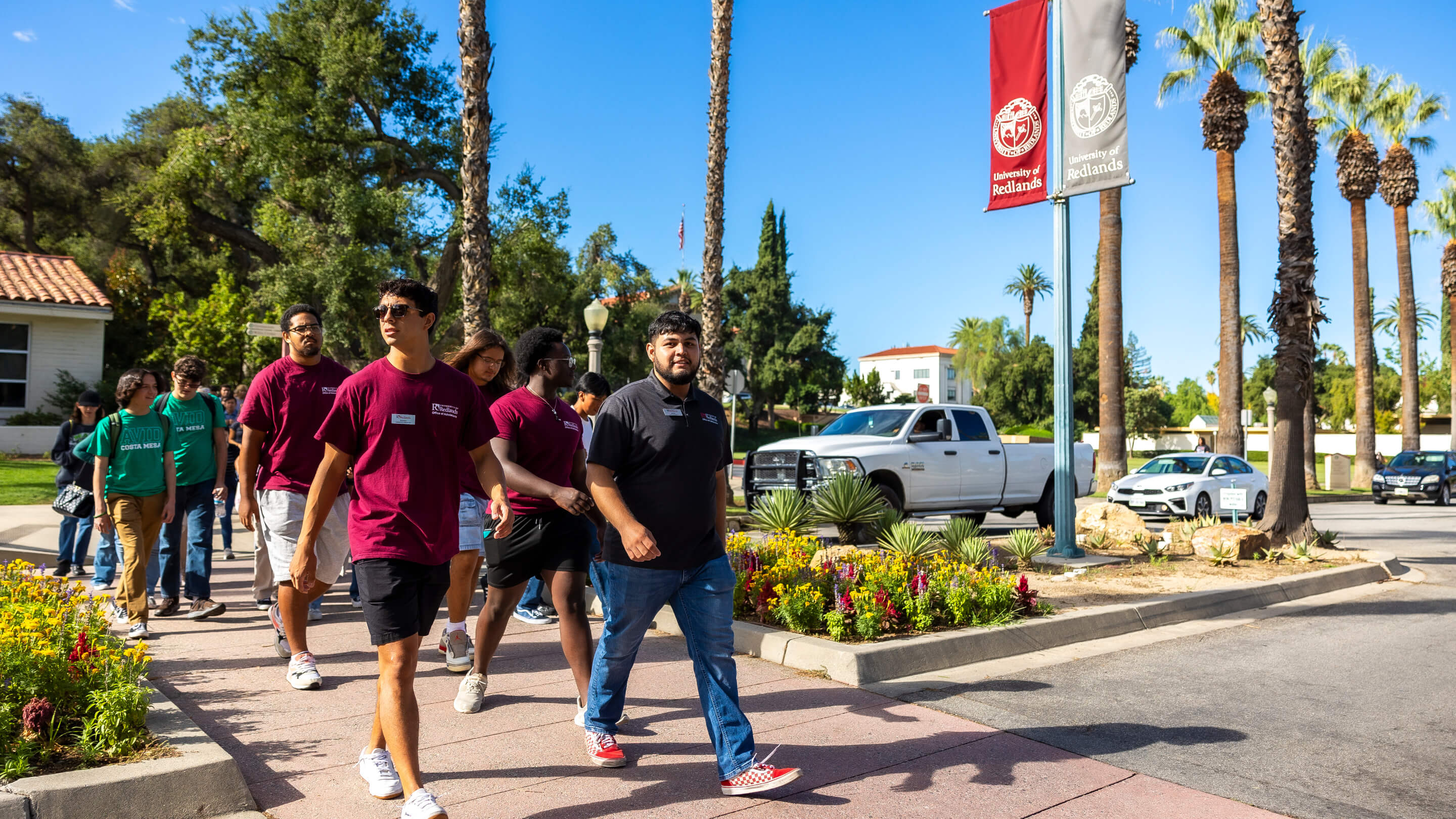 a group of people walking on a sidewalk