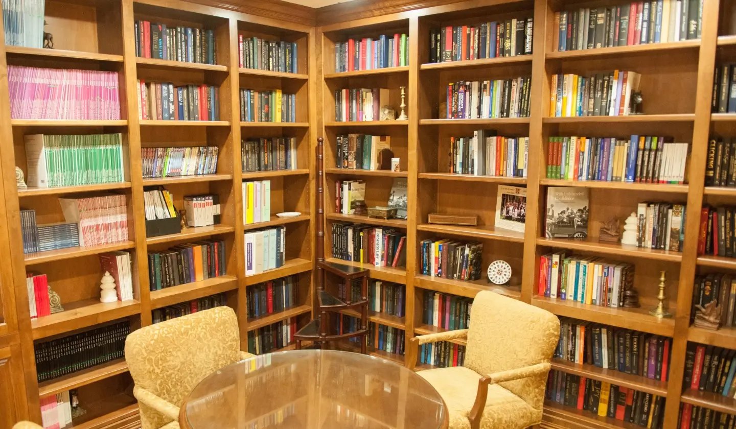 a room with bookshelves and chairs