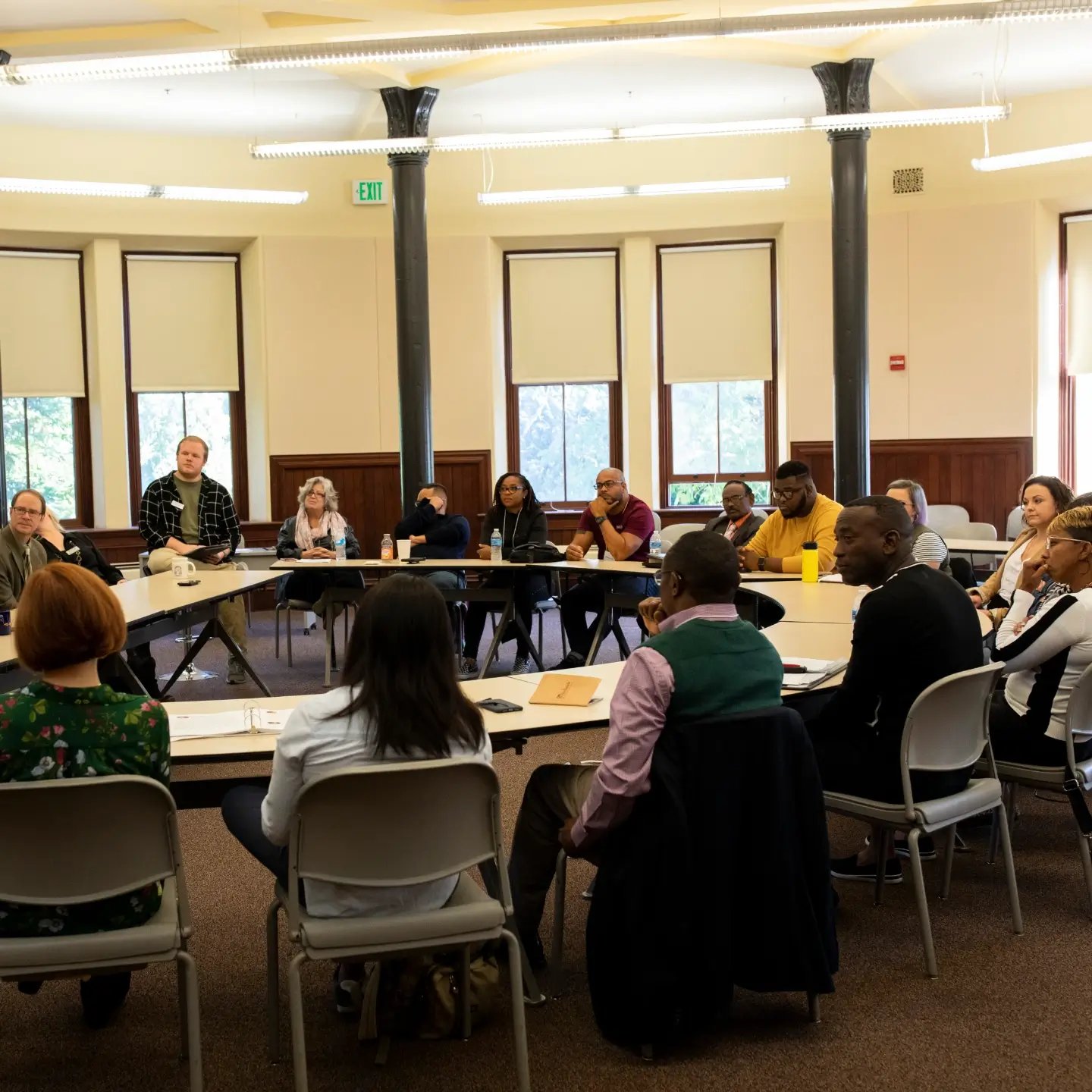 a group of people sitting at tables in a room