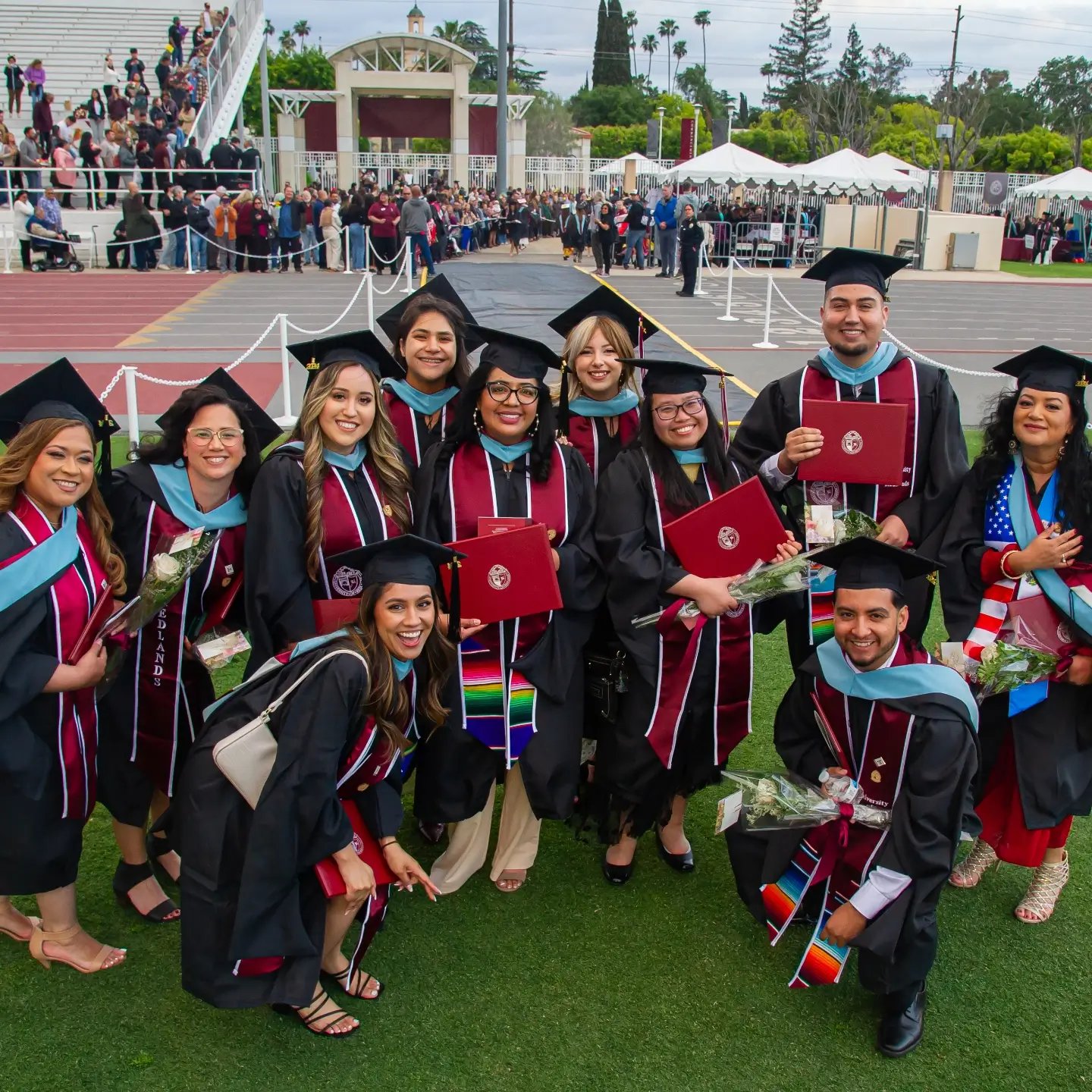 a group of people in graduation gowns and caps