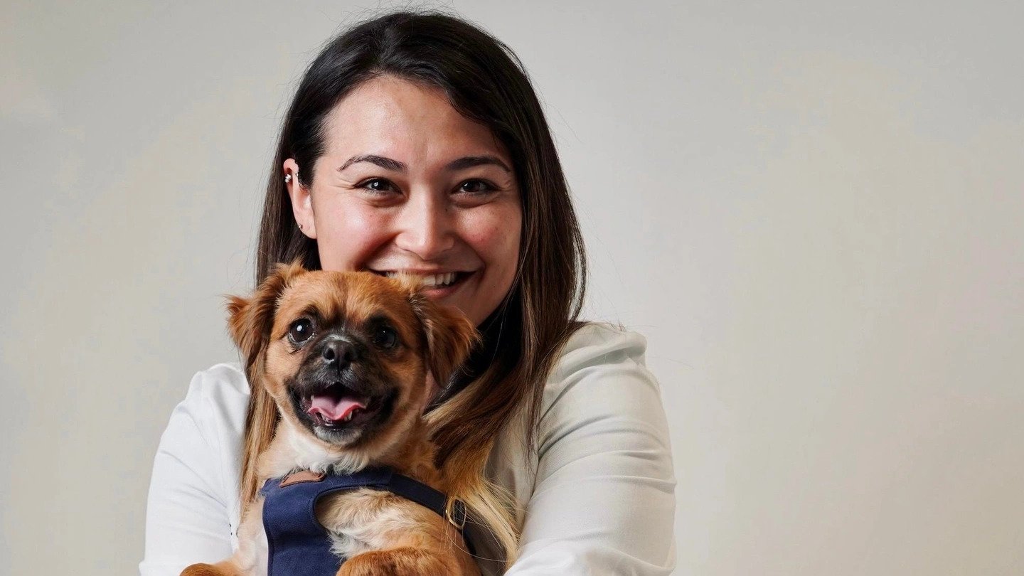 a woman holding a dog