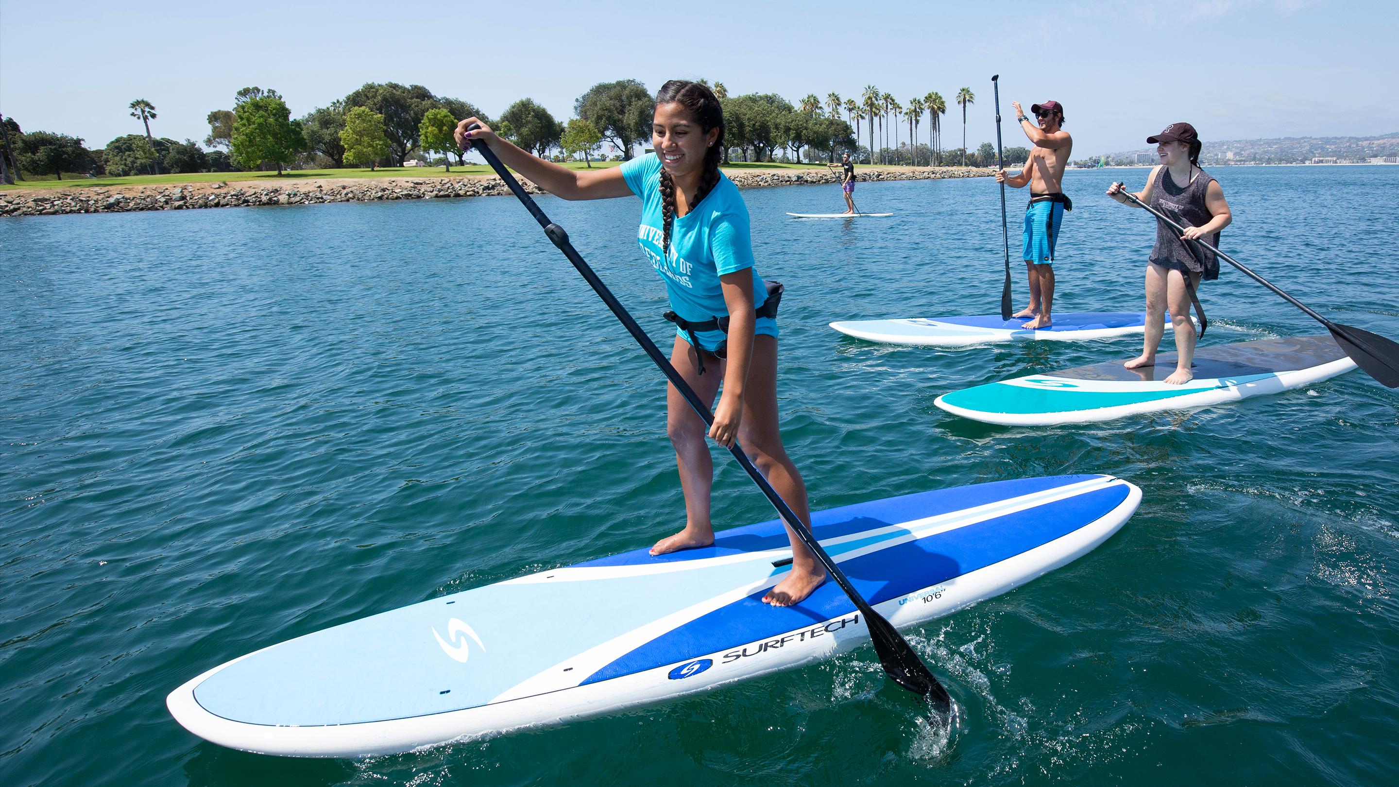 a woman on a paddle board