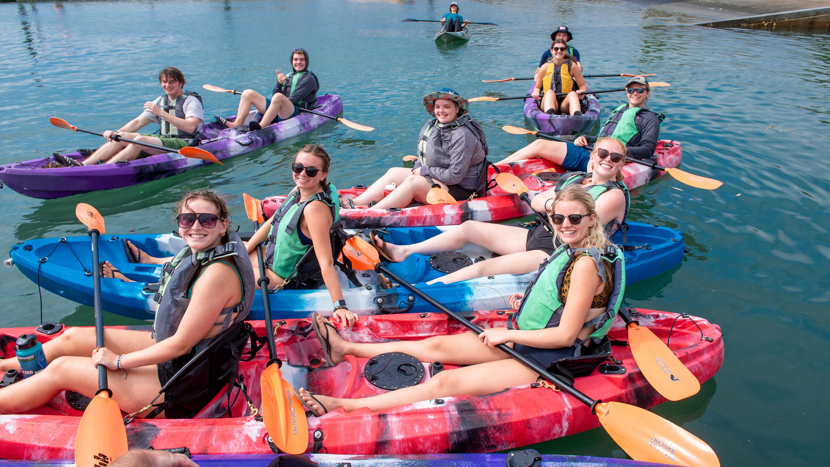 a group of people in kayaks
