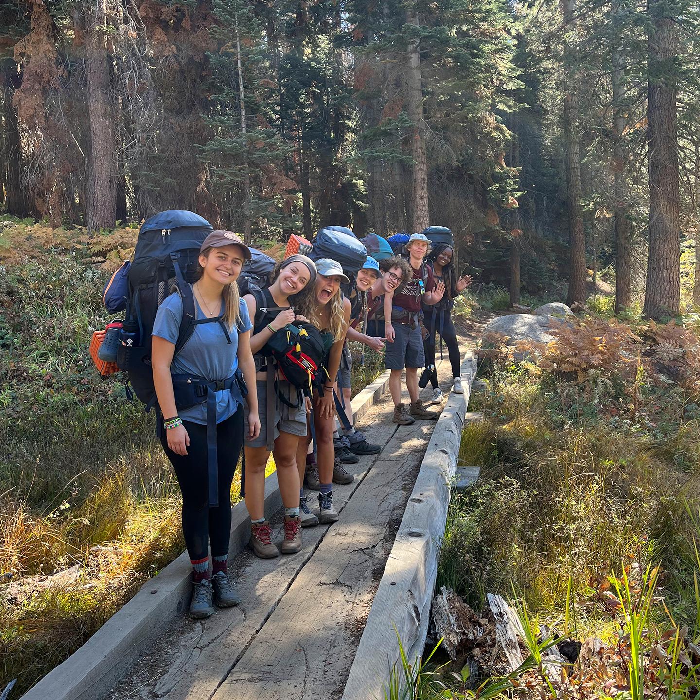 a group of people with backpacks on a trail