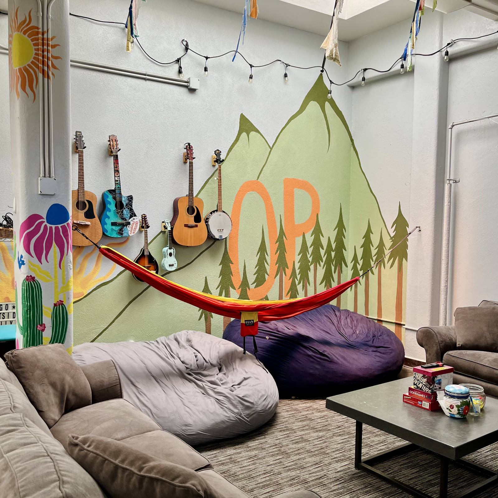 a room with couches and guitars