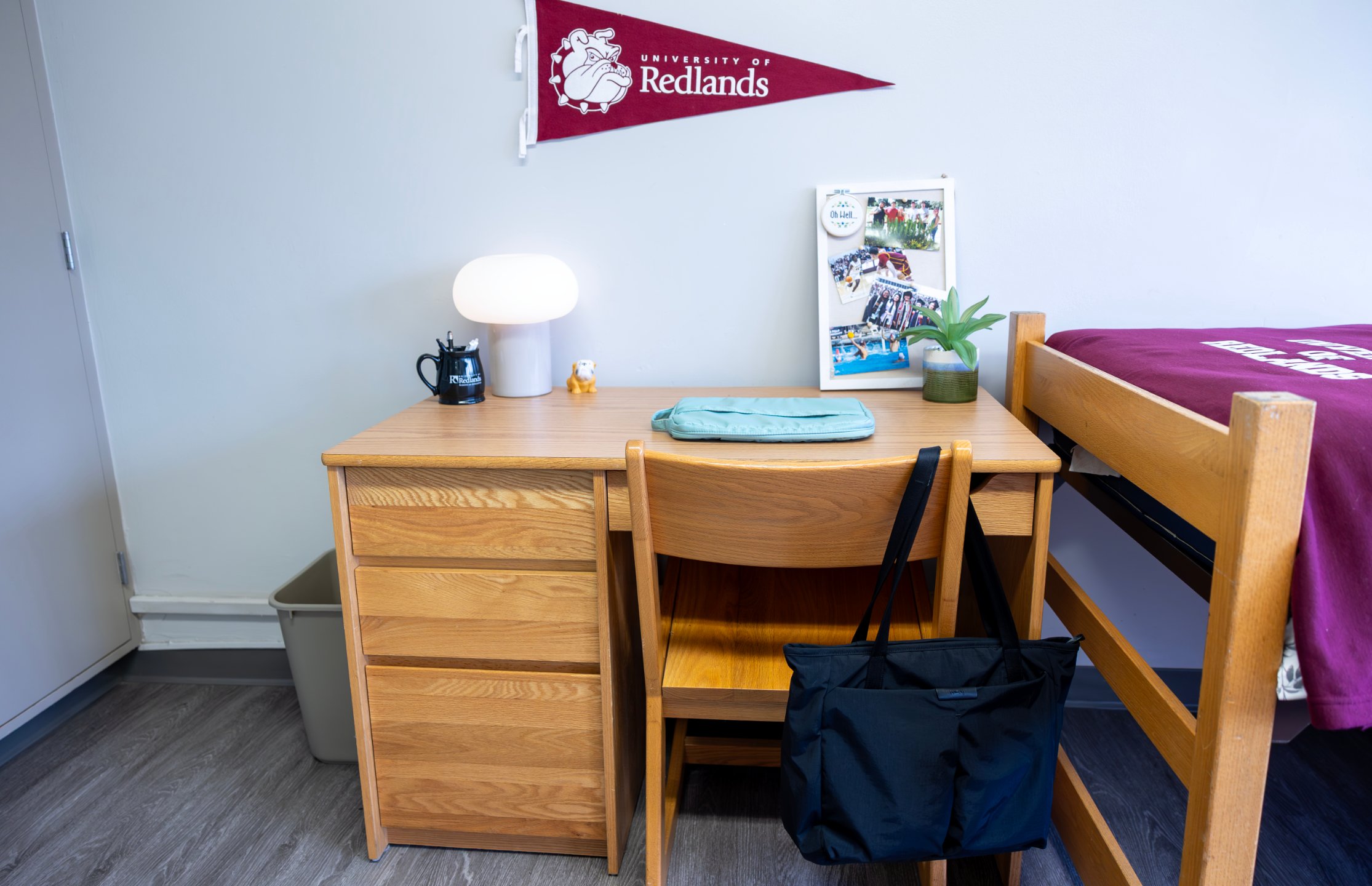 a desk with a chair and a bag on it